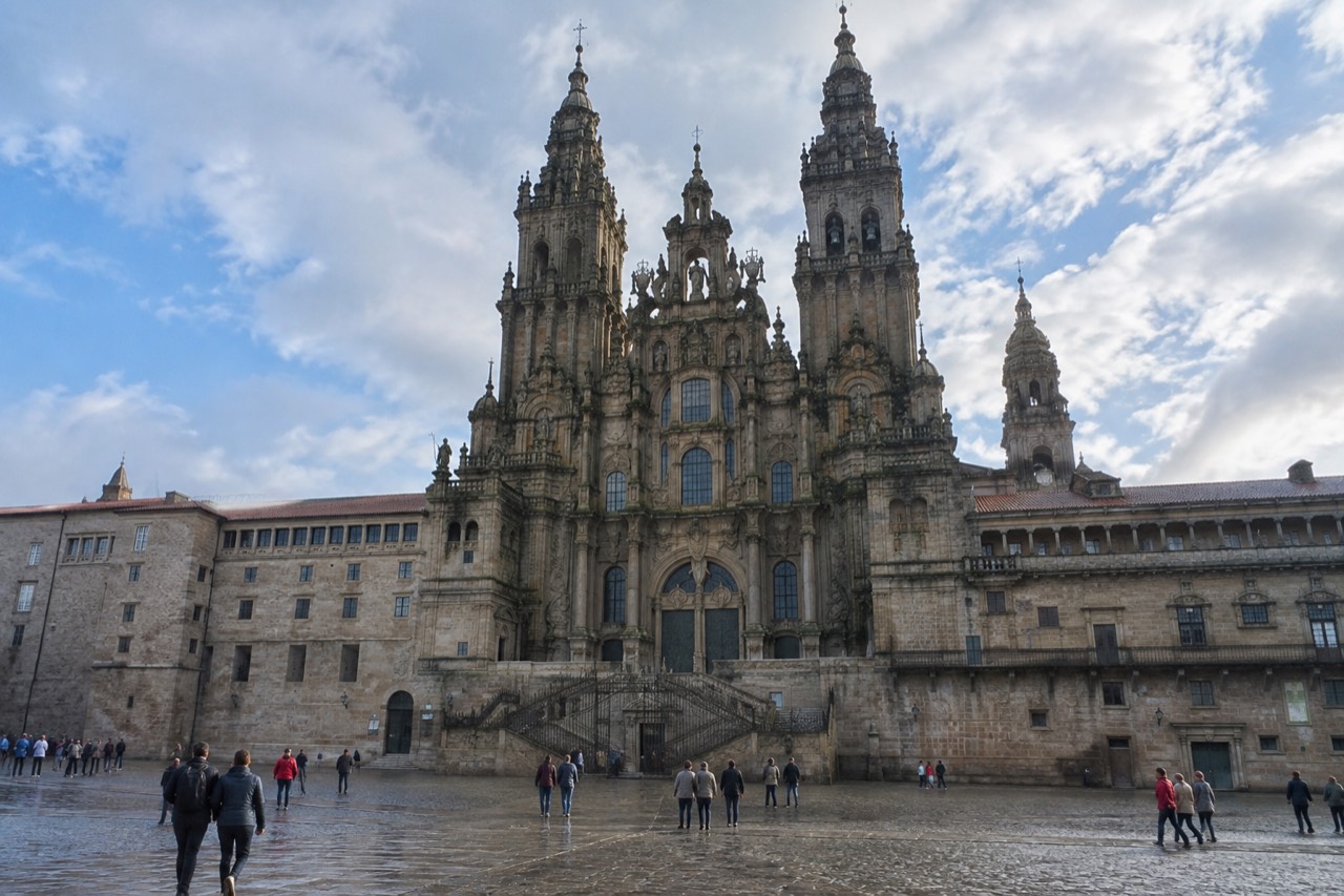 The baroque facade of Santiago de Compostela Cathedral seen from Praza do Obradoiro on a bright morning