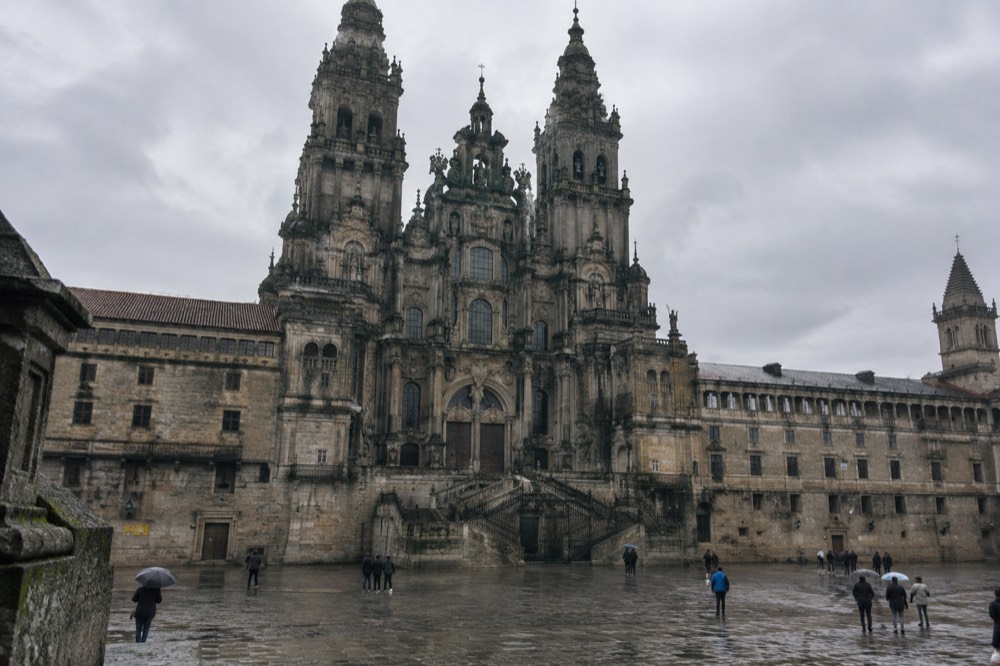 Rain-slicked granite street with old stone buildings in Santiago de Compostela