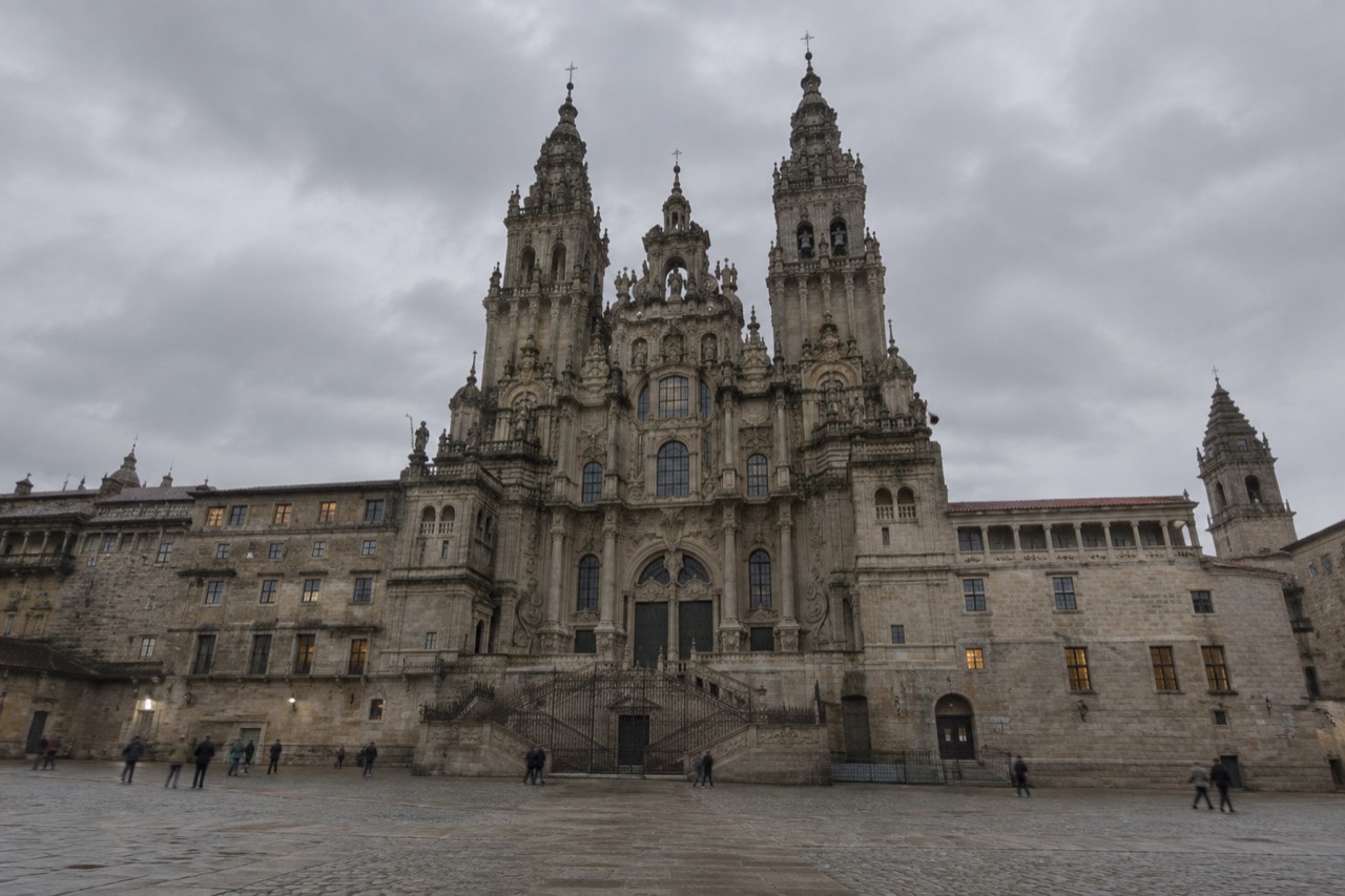 The baroque facade of Santiago de Compostela Cathedral rising above Praza do Obradoiro at dusk