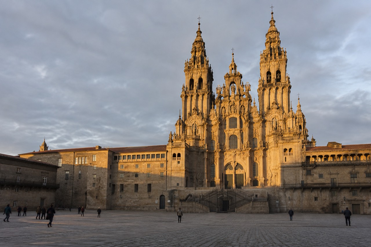 The baroque facade of Santiago de Compostela Cathedral rising above Praza do Obradoiro at golden hour