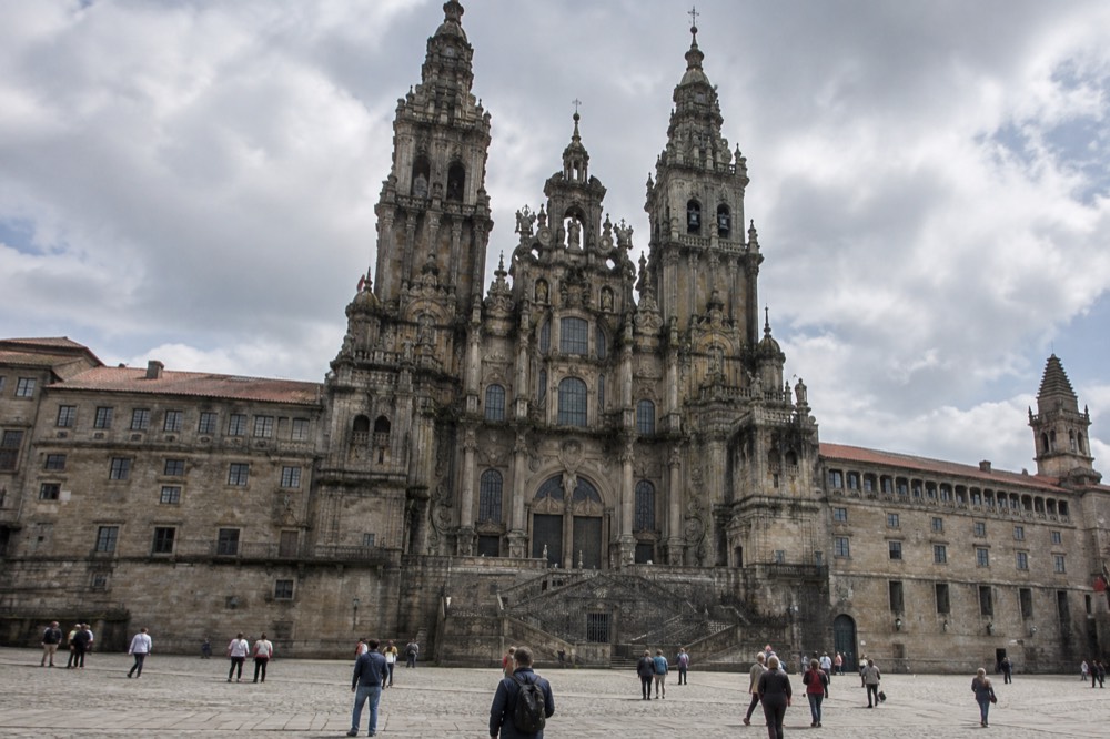 A slate kitchen counter in Santiago de Compostela laid with octopus on potatoes, red peppers and a whole almond cake