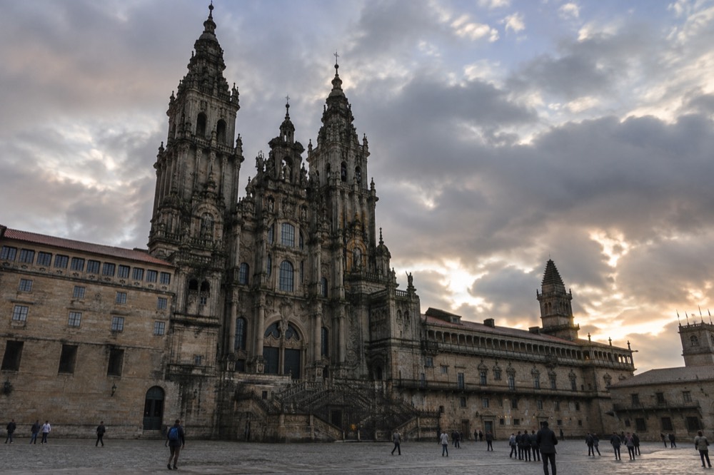 The baroque western facade of Santiago de Compostela Cathedral seen from Praza do Obradoiro at dusk