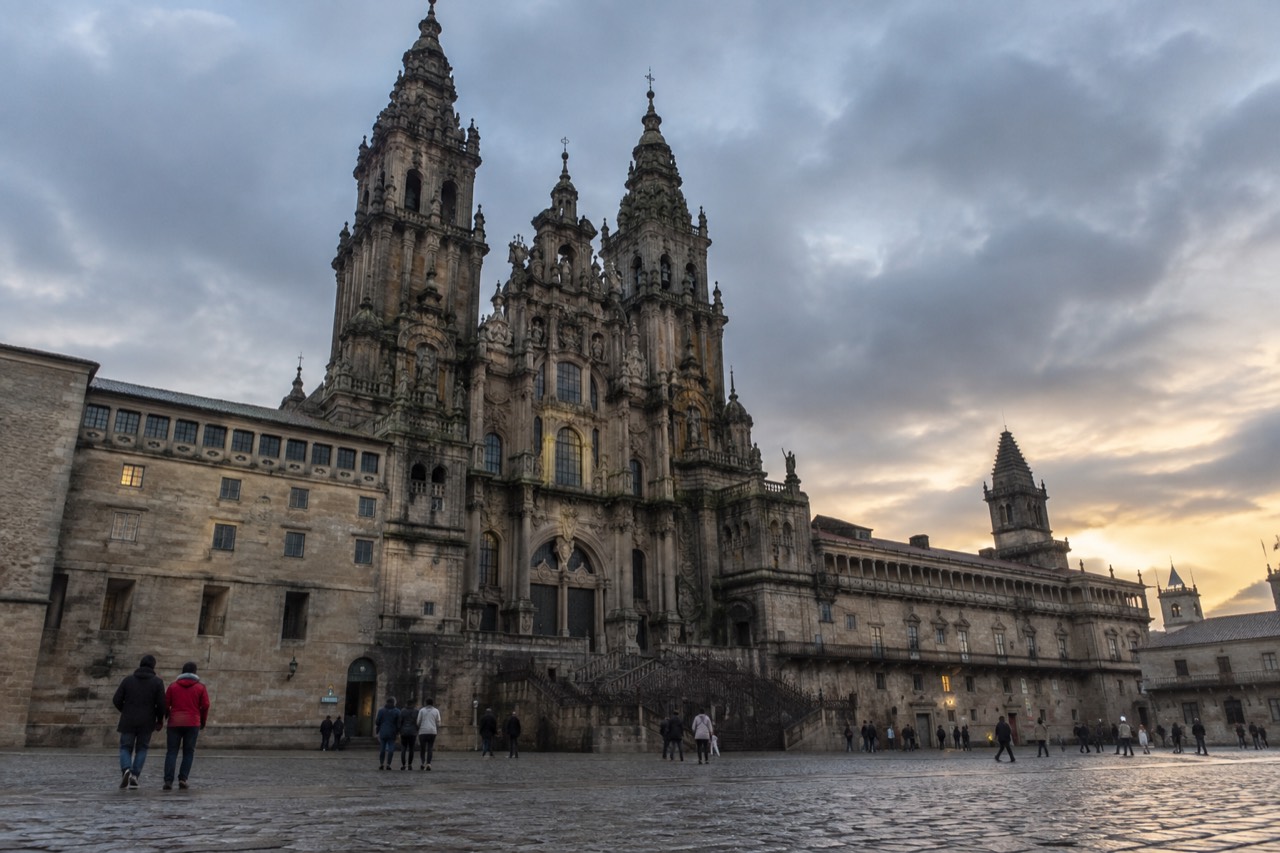 The baroque Obradoiro facade of Santiago de Compostela Cathedral rising above the square at dusk