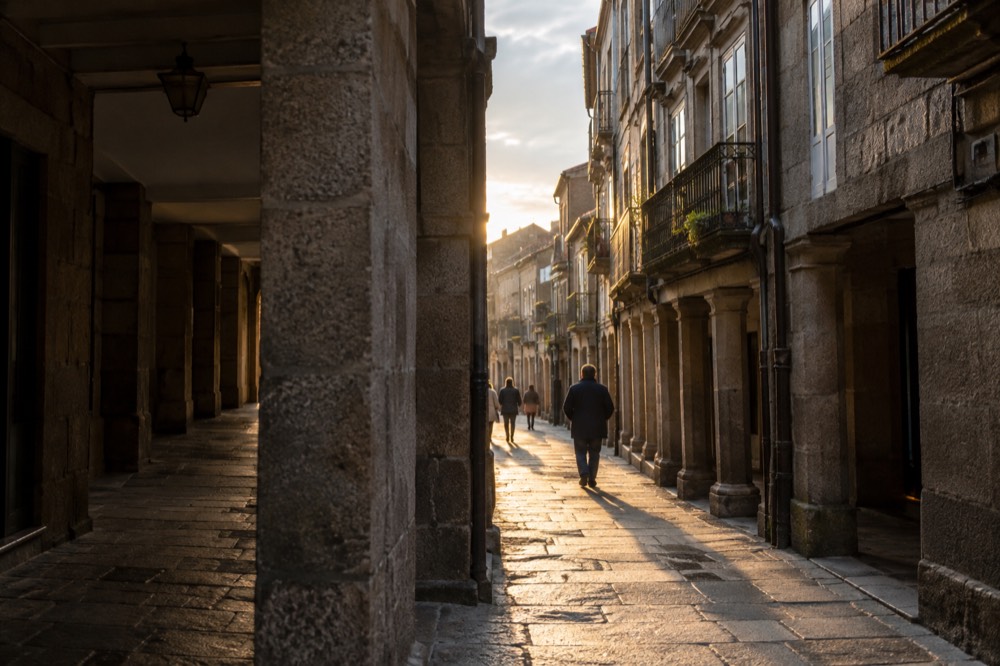 Narrow granite pedestrian street with wrought iron balconies in the old town
