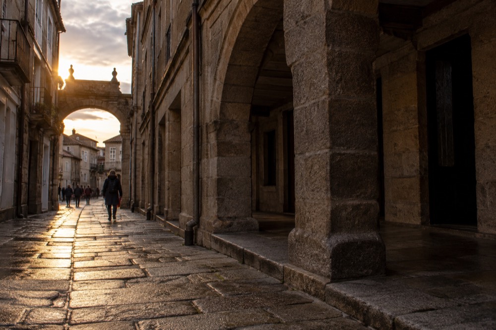 Stone archway marking a pilgrim entrance street into the old town