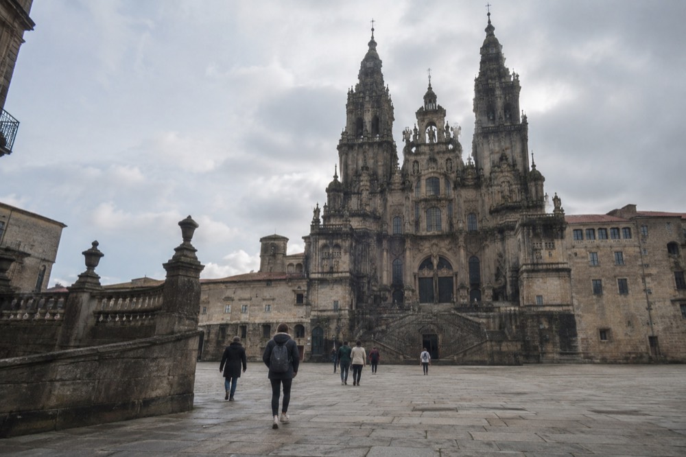 Curved stone balustrade of the Paseo da Ferradura with the cathedral towers of Santiago de Compostela across the rooftops