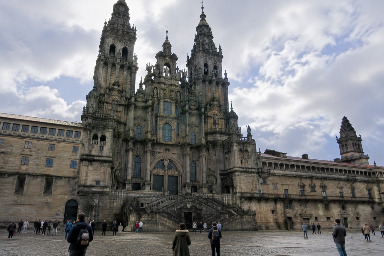 The incense-filled nave of Santiago de Compostela Cathedral seen from the transept, with the dome crossing above the altar