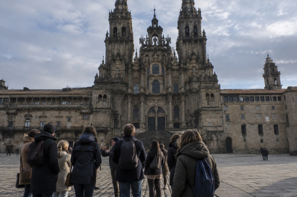 Guide speaking to a small group outside the cathedral in Santiago de Compostela