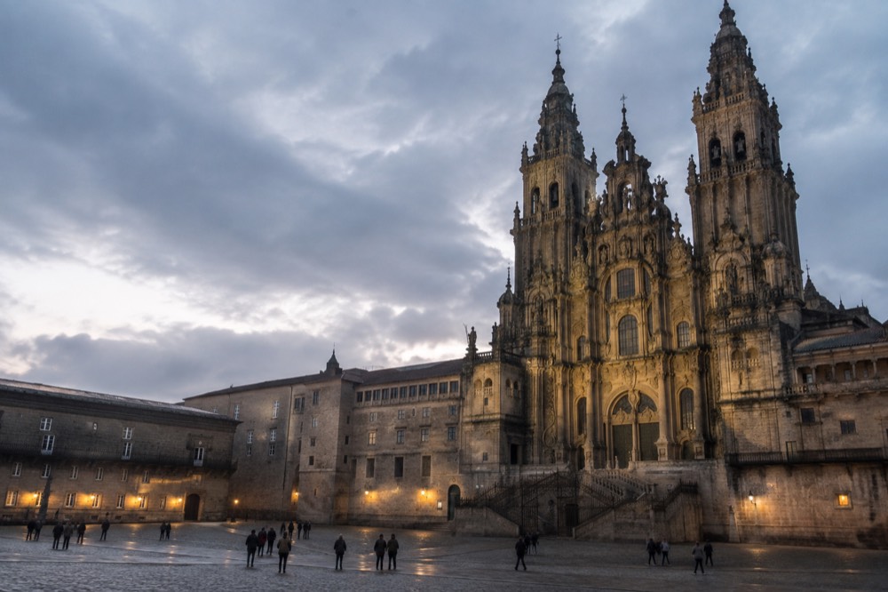 Evening light on Praza do Obradoiro with the Parador on one side and the lit cathedral facade on the other