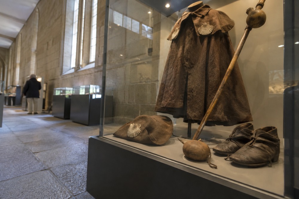 Close view of historical pilgrim artifacts in a glass display case with soft museum lighting