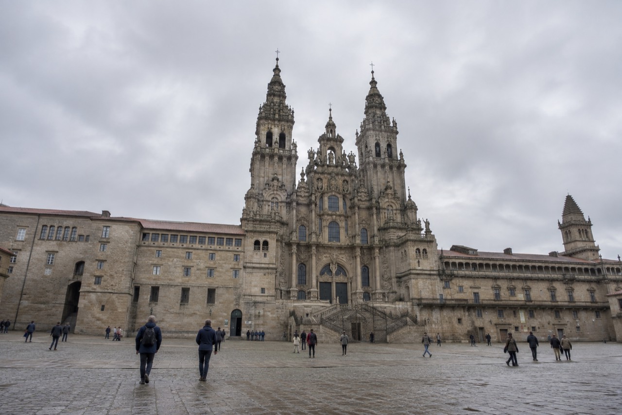 The baroque western facade of Santiago de Compostela Cathedral rising above the wide stone Praza do Obradoiro