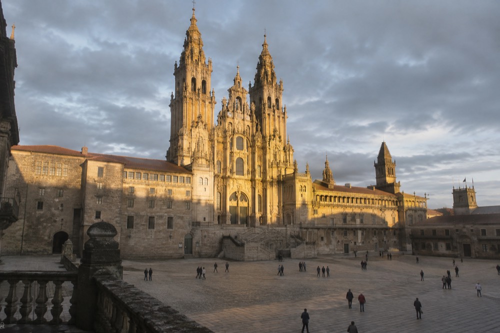Low evening light striking the west towers of the Cathedral above the empty square
