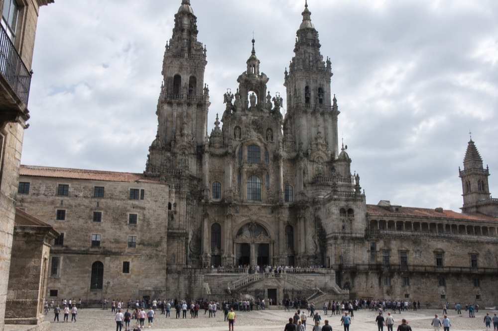 Visitors gathered near the entrance of the Cathedral facade at midday on the square