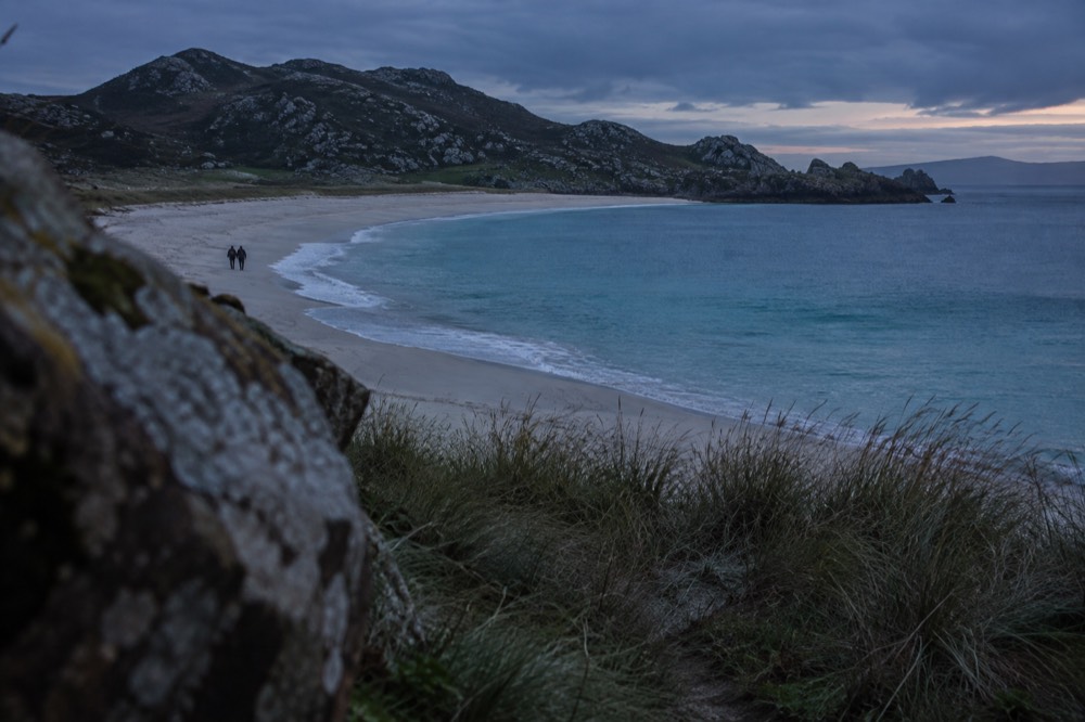 Grass-topped cliffs dropping to the open Atlantic with waves breaking below