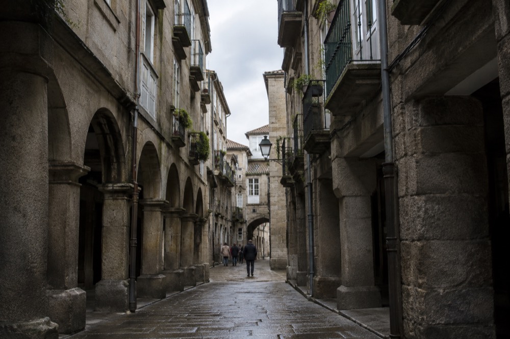 Narrow granite street with balconied apartment buildings in Vigo's old town