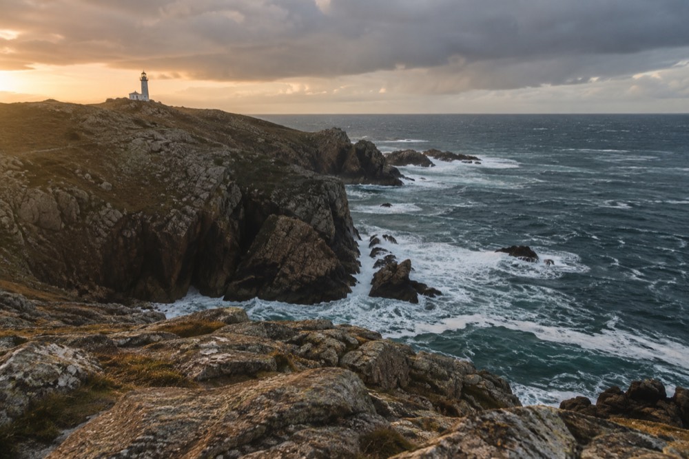 Lighthouse on a rocky cape above the Atlantic on the Costa da Morte coast