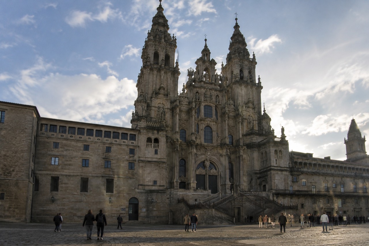 The baroque facade of Santiago de Compostela Cathedral seen from Praza do Obradoiro under a soft morning sky