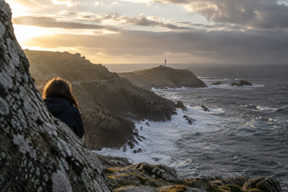 The ocean horizon from a granite headland on the Costa da Morte at golden hour
