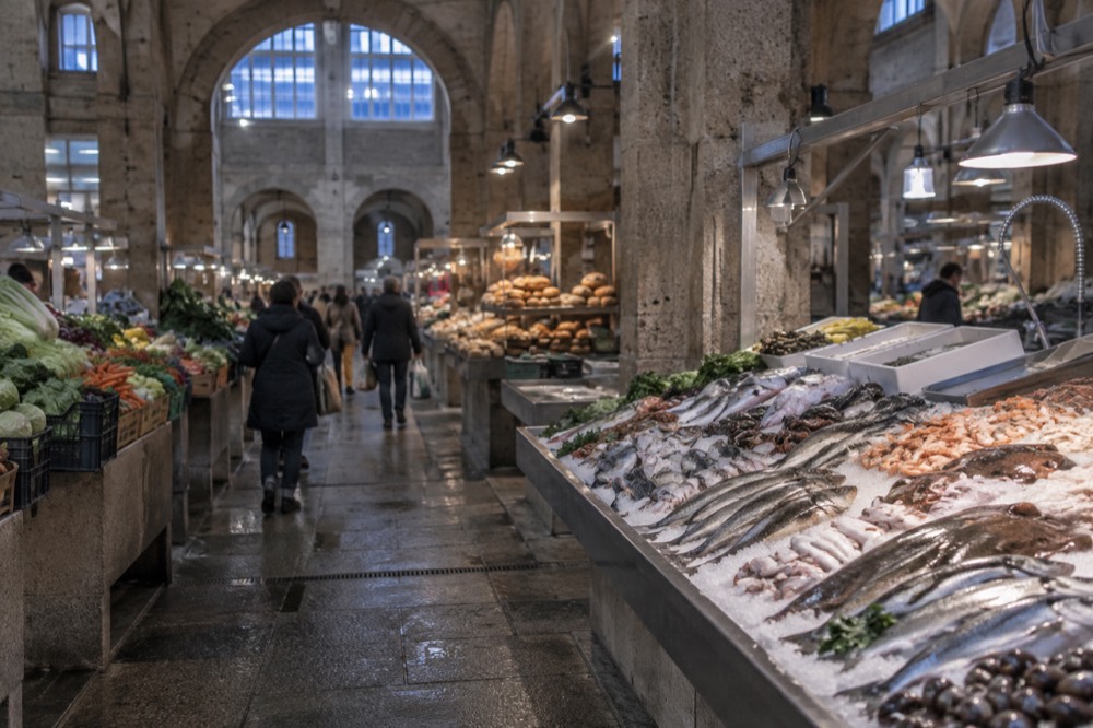 A bustling food market hall with stalls of vegetables, fish and bread in Santiago de Compostela