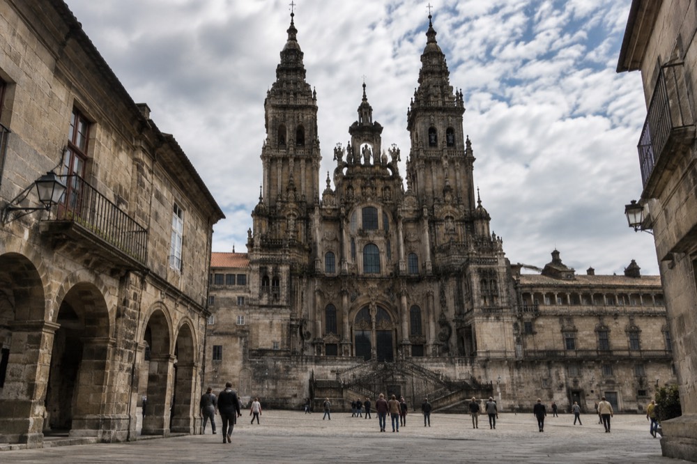 Stone arches of the old town of Santiago de Compostela with the cathedral towers rising above rooftops