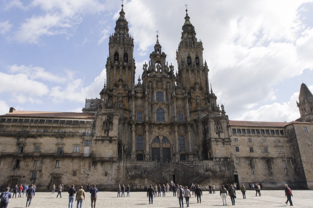 The baroque facade of Santiago de Compostela Cathedral seen from a wide stone square