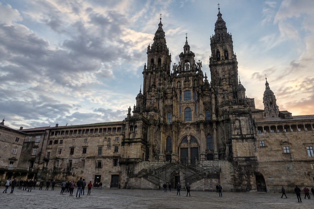 The baroque facade of the Cathedral of Santiago de Compostela seen from Praza do Obradoiro in the evening
