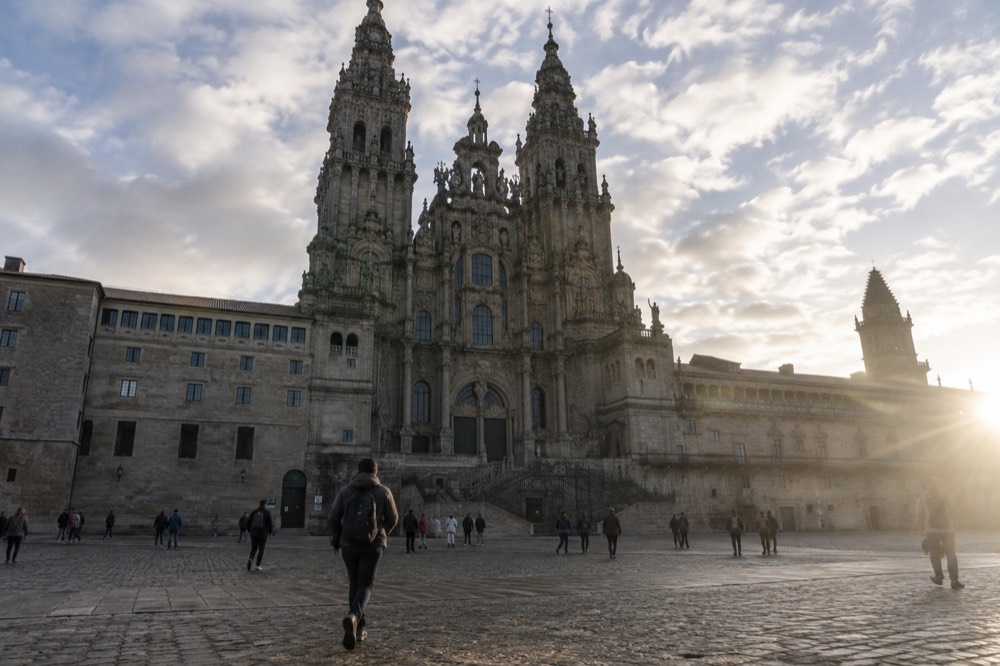 The baroque facade of the Cathedral of Santiago de Compostela seen from the large granite square in front of it