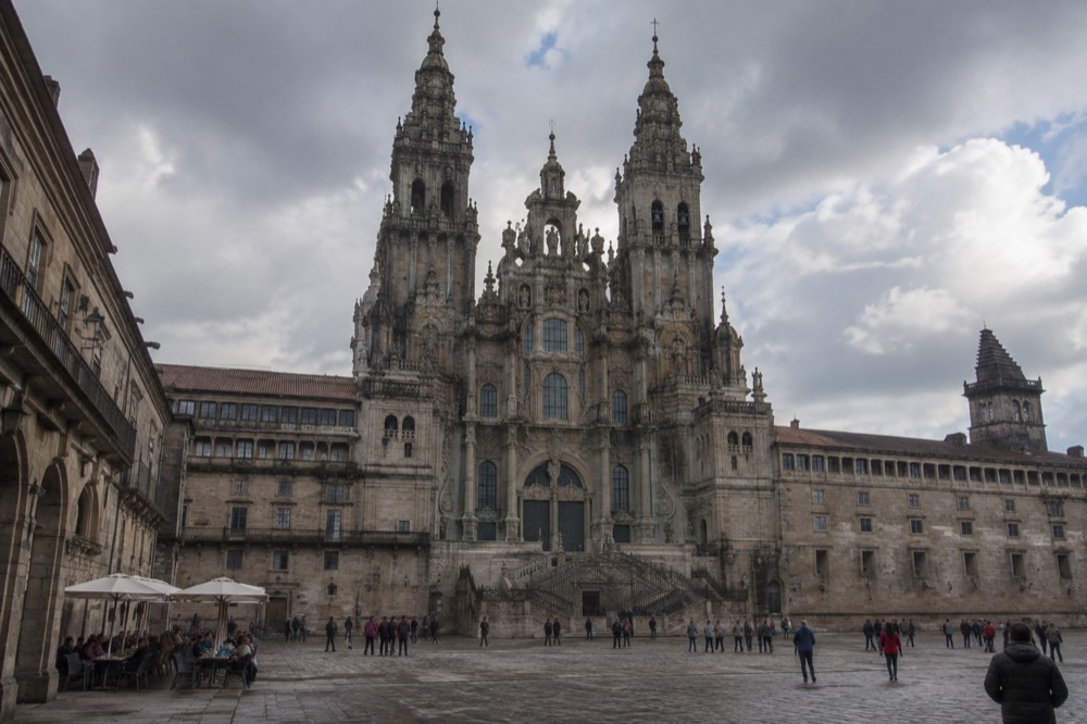A wide granite square lined with historic buildings under festival lights