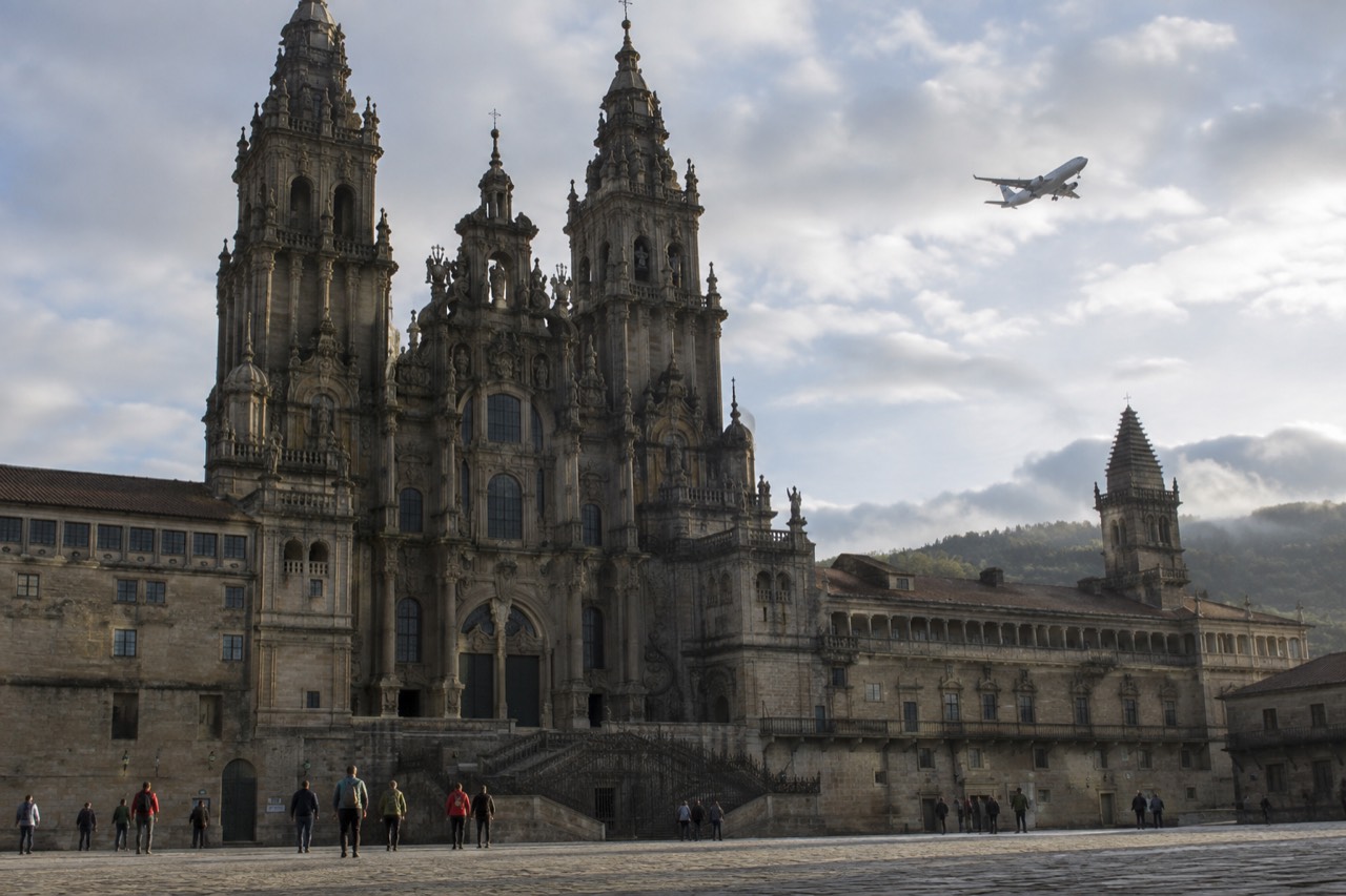 A plane descending over green Galician hills toward the airport outside Santiago de Compostela