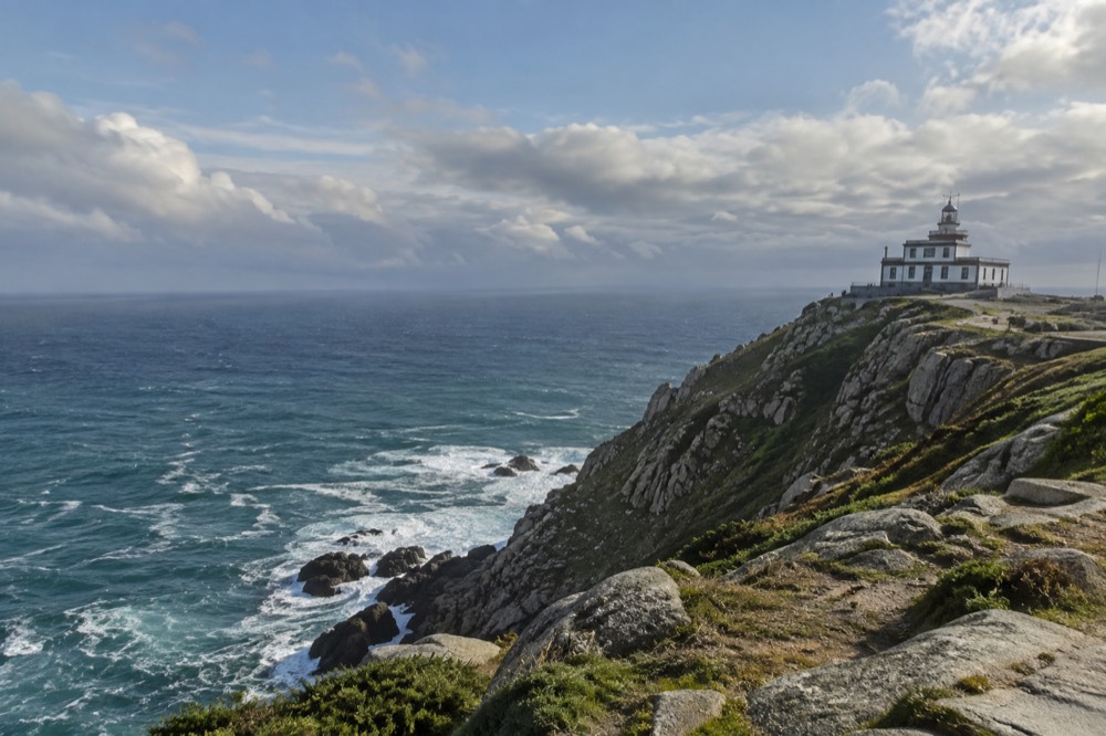 Turquoise water and pine-covered cliffs on the Atlantic coast of Galicia near Fisterra