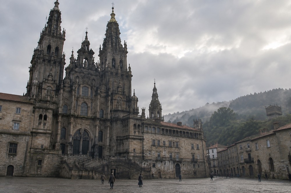 Green misty Galician hills with a traditional stone granary on raised pillars