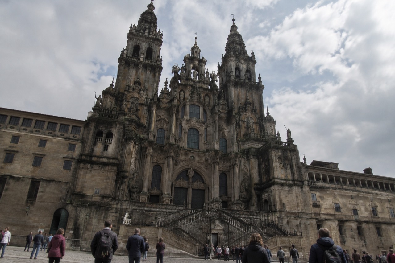 Interior of Santiago de Compostela Cathedral with the high altar and pilgrims seated for mass