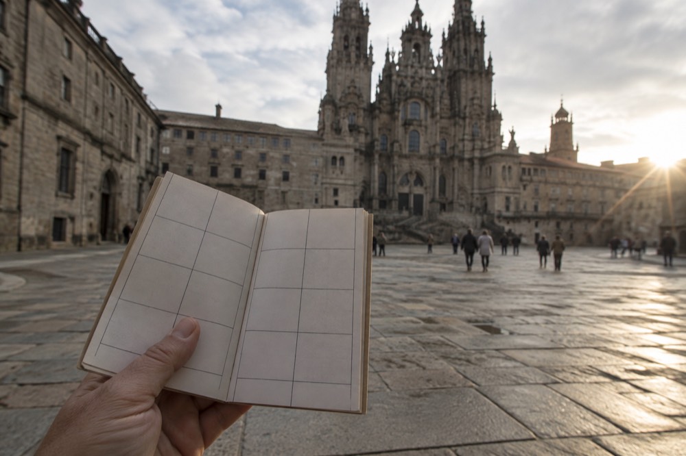 A close view of a credencial's folded pages showing a grid of blank stamp boxes ready for the walk