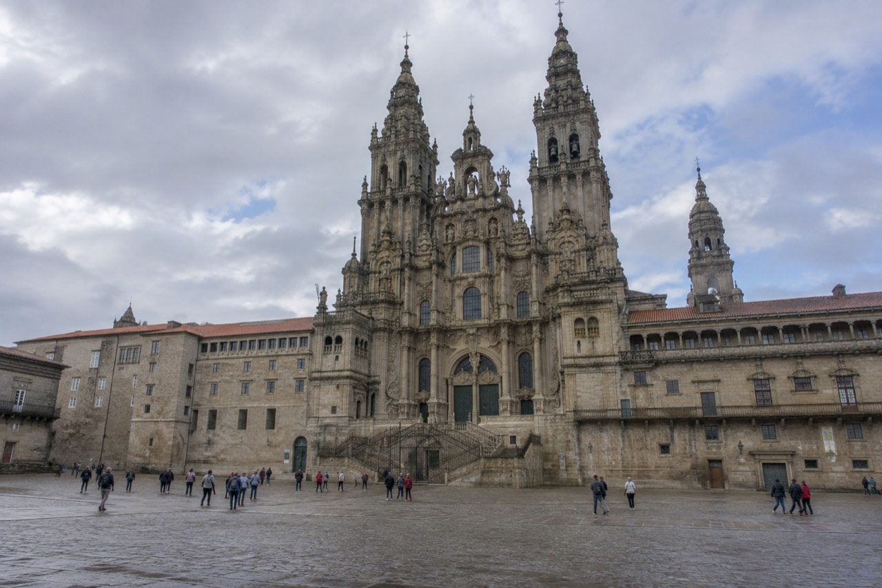 The baroque western facade of Santiago de Compostela Cathedral rising above Praza do Obradoiro on a bright morning