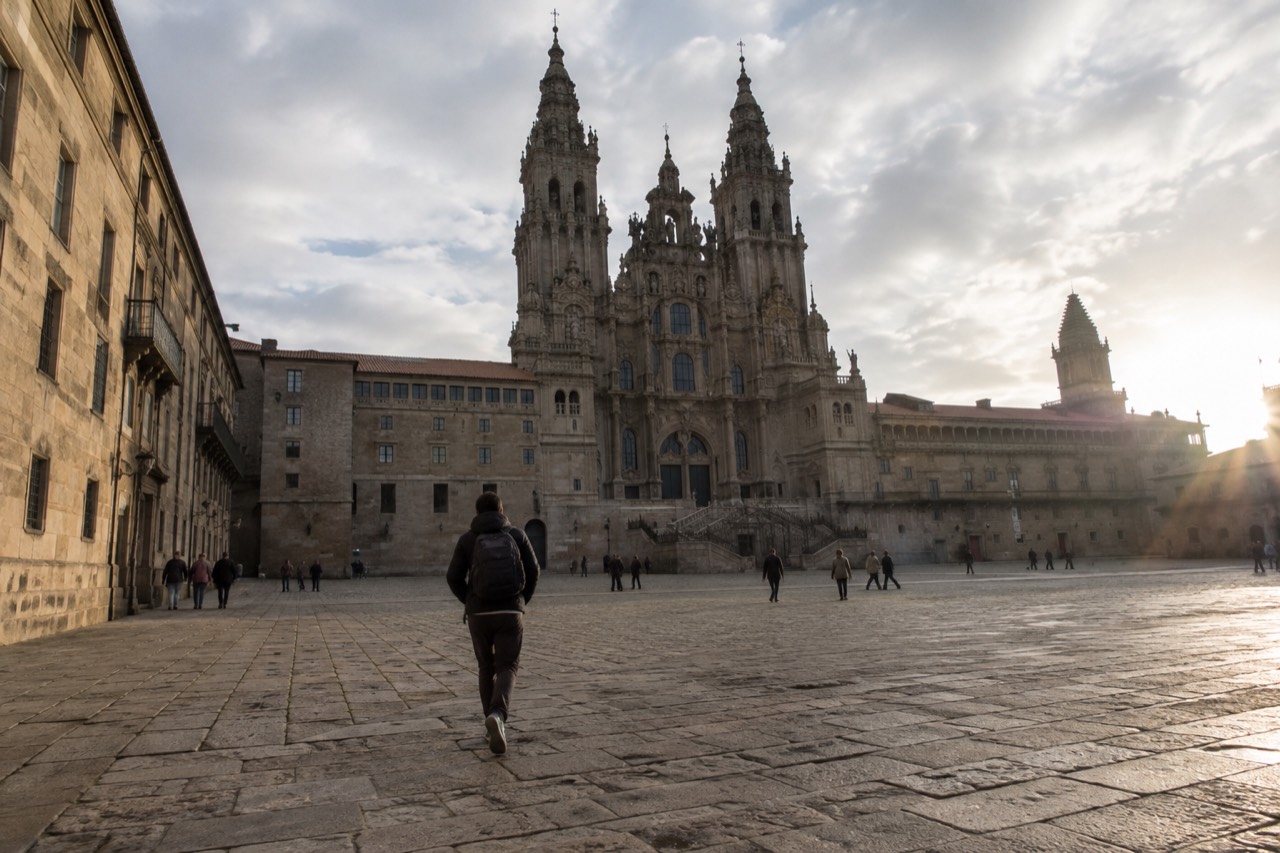 The baroque facade of Santiago de Compostela Cathedral seen across the wide stone Praza do Obradoiro