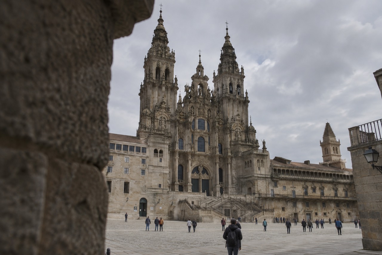 The bar granite facade of Santiago de Compostela Cathedral rising above Praza do Obradoiro on a bright morning