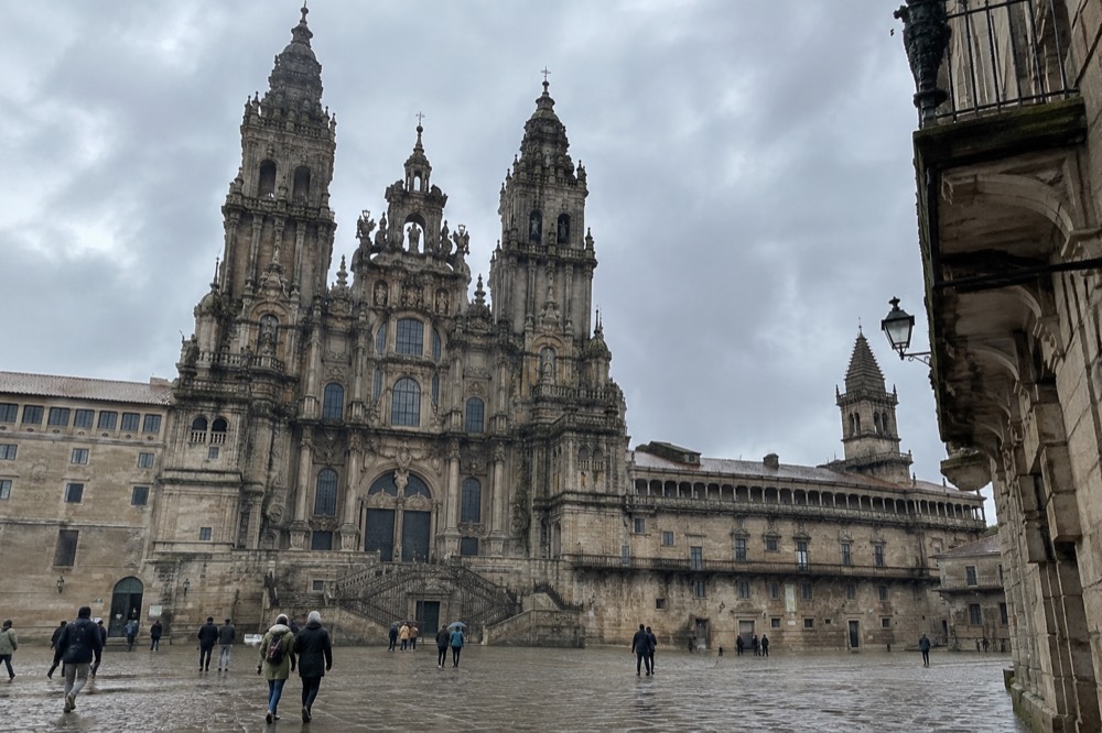 A regional train waiting at Santiago de Compostela station on a grey Galician morning