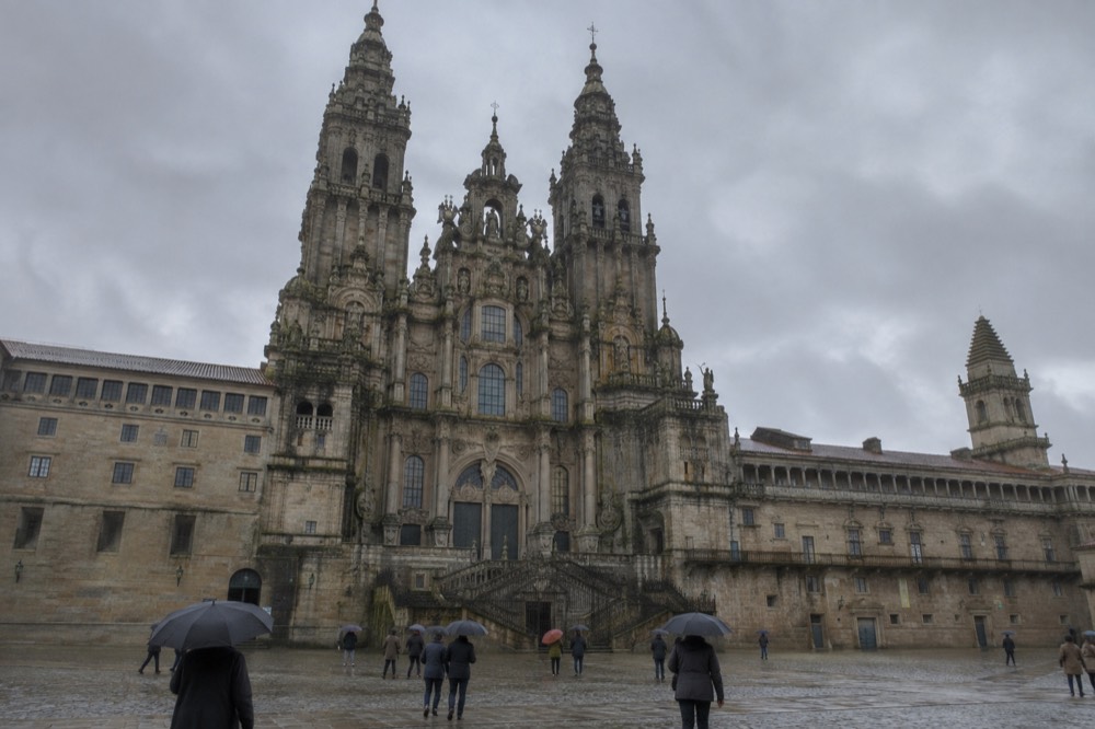 The interior of Santiago de Compostela Cathedral under soft light with rain outside