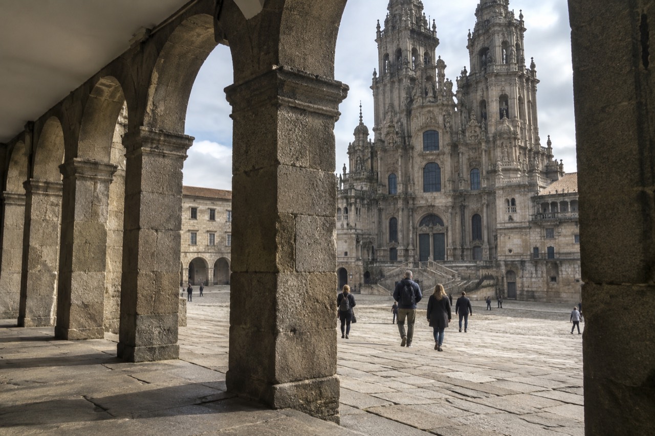Granite arcades and a sloping stone square in front of Santiago de Compostela Cathedral