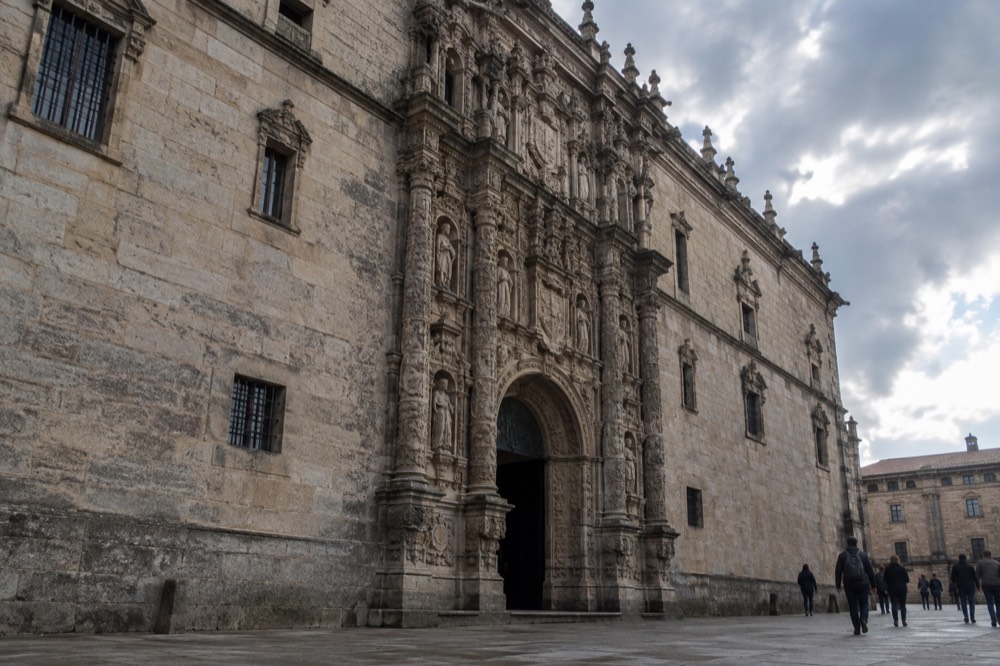 Plateresque facade of a historic granite building on a broad stone square