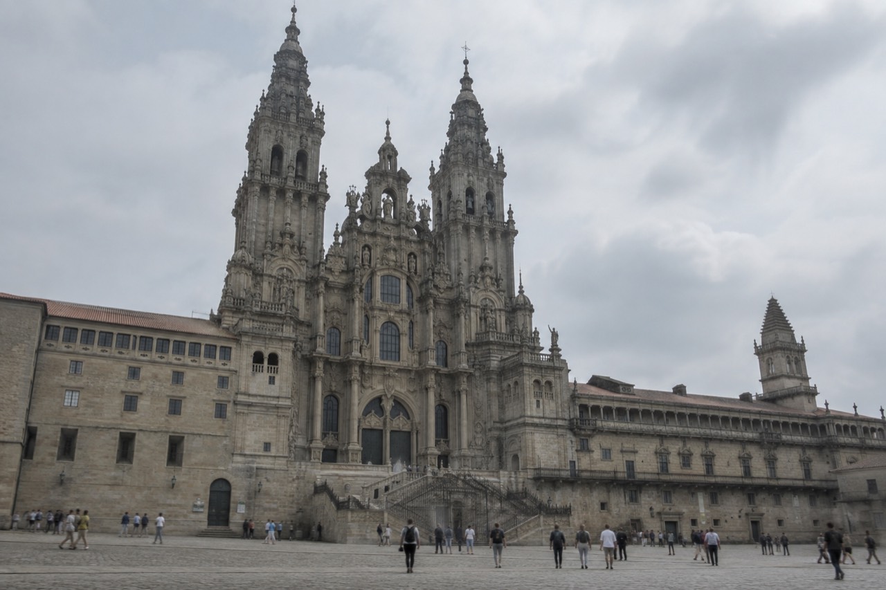 The granite facade of Santiago de Compostela Cathedral rising above Praza do Obradoiro at midday