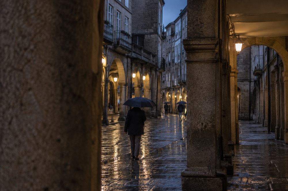 Rain falling on the granite arcades of a colonnaded street in the old town
