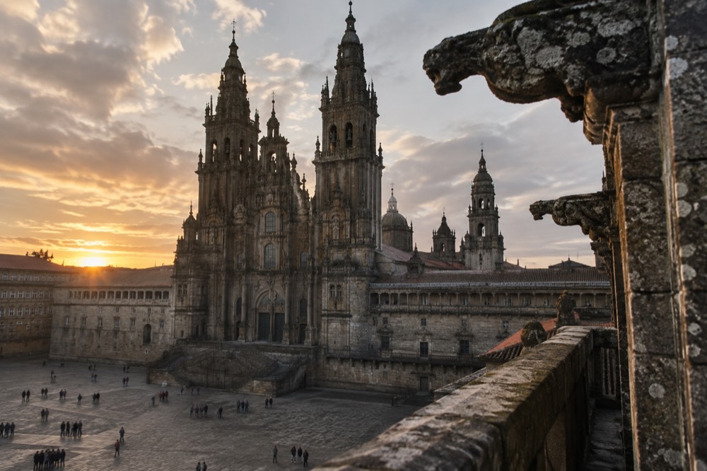 Stone gargoyles and the bell towers of Santiago Cathedral seen from the rooftop walkway