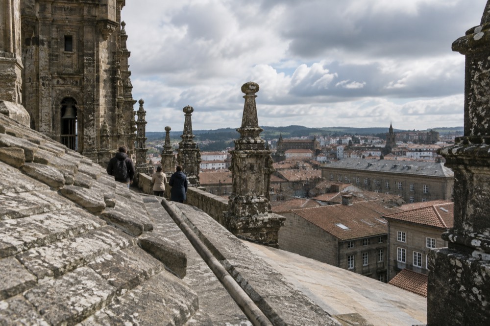 Visitors on the Cathedral rooftop walkway looking over the towers and rooftops of Santiago de Compostela